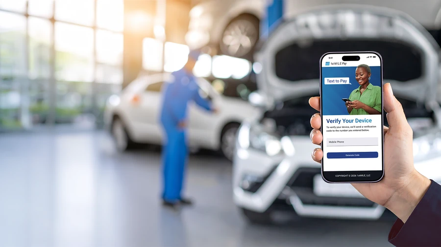 Customer approving a Text-to-Pay payment on their phone at an auto shop service counter