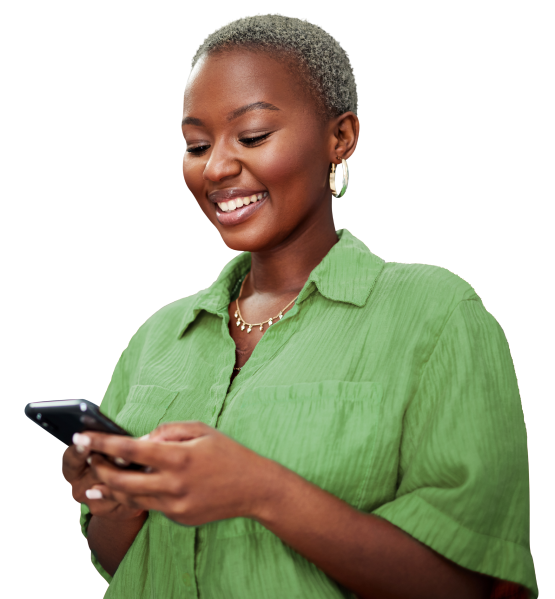 a woman smiling looking at her phone in her hands